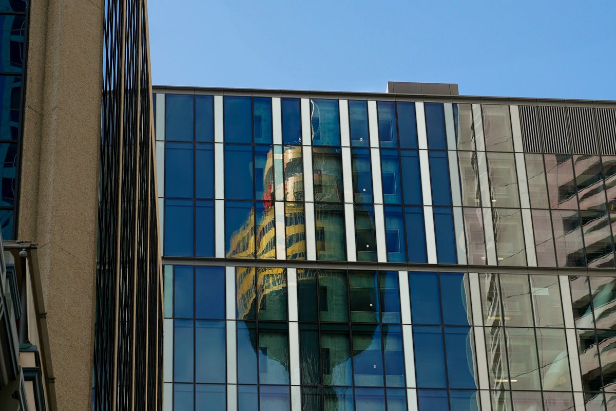 Sydney CBD office tower reflected in a modern commercial glass facade